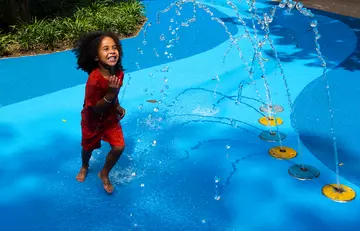 A child plays in the Splash Zone in Animal Adventure