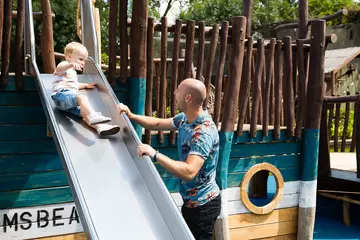 A father with his son on the slide in Animal Adventure at London Zoo