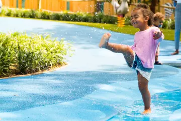 A little girl plays in the Animal Adventure Splash Zone at London Zoo