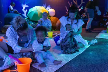 Babies and mothers participating in the Baby Sensory Stories Experience at London Zoo 