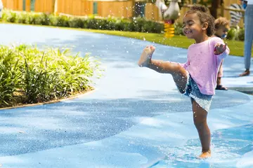 child playing in the fountains at the Splash zone at London Zoo Animal Adventure