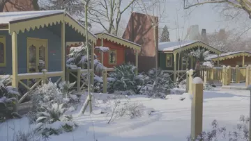 Blue and red lodges with yellow trim are covered with a thick blanket of snow