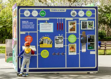A child on a scooter interacting with the ZSL at 200 exhibition