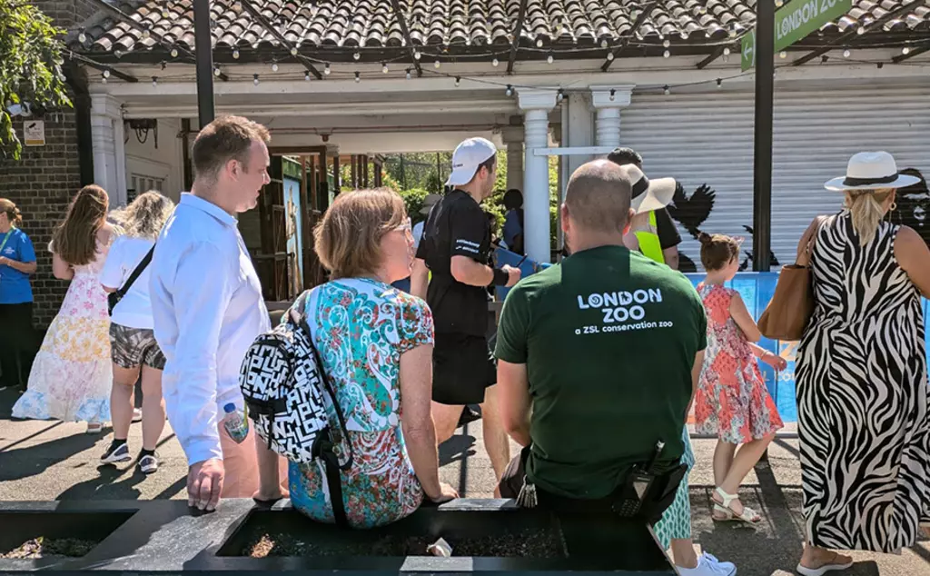 people looking at banksy mural