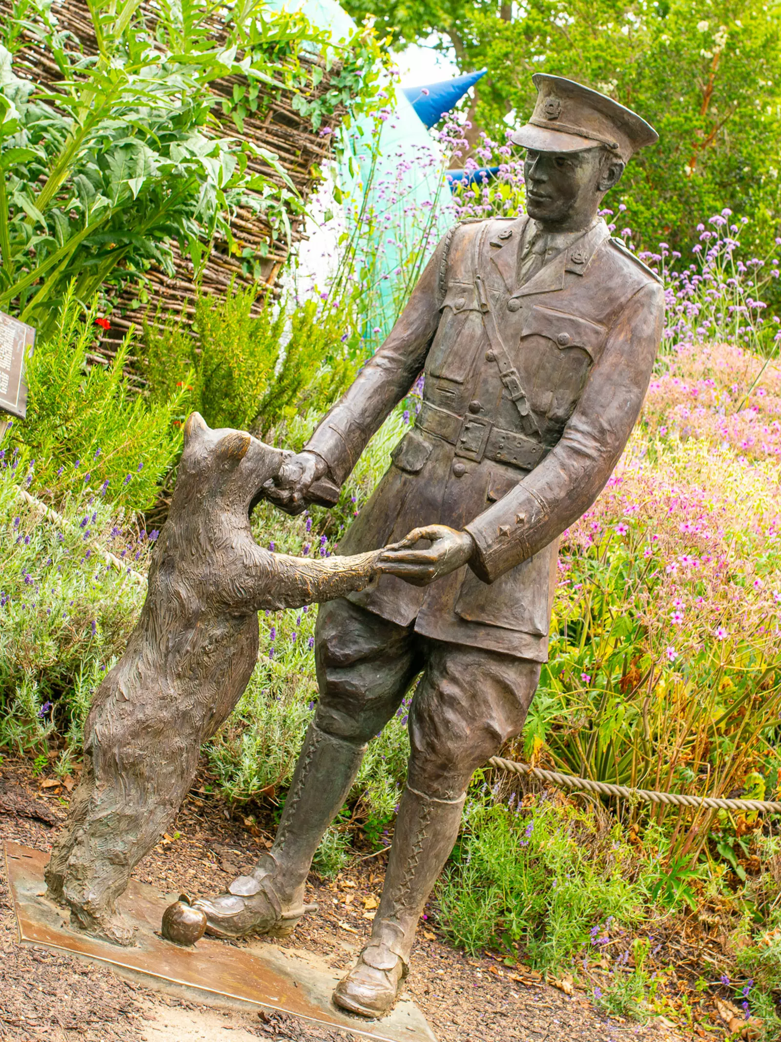 Statue of Winnie the bear being fed by Lieutenant Harry Colebourn at London Zoo