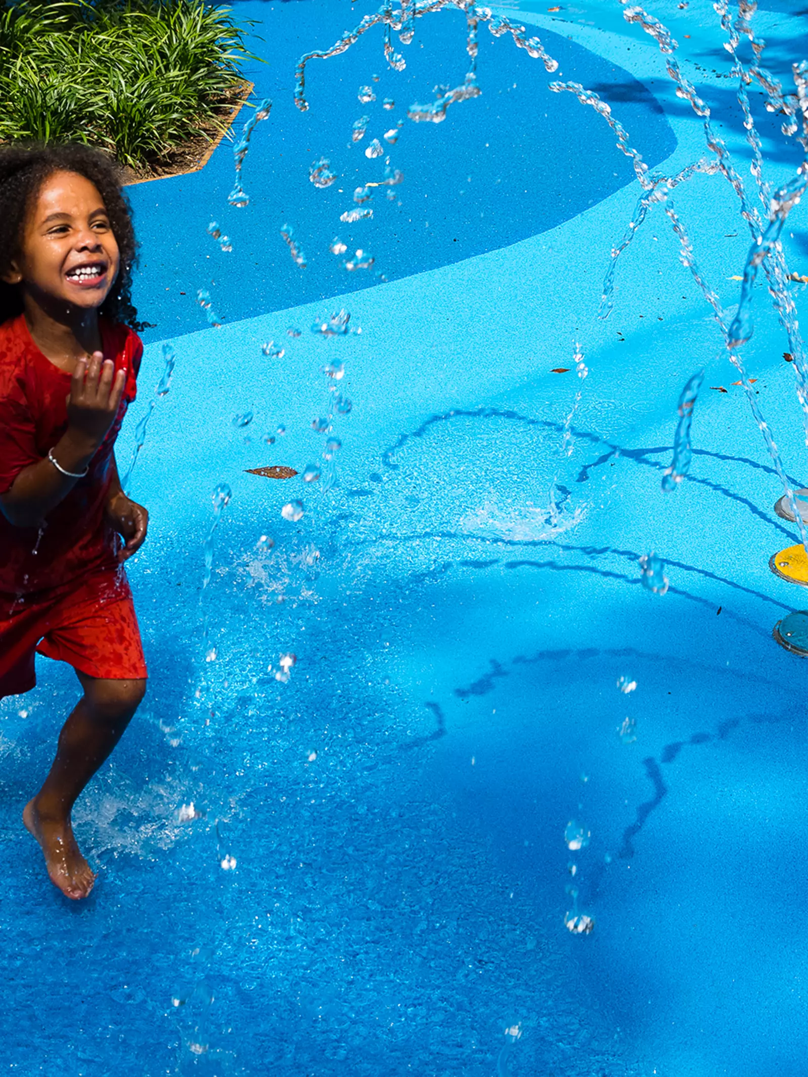 A child plays in the Splash Zone in Animal Adventure