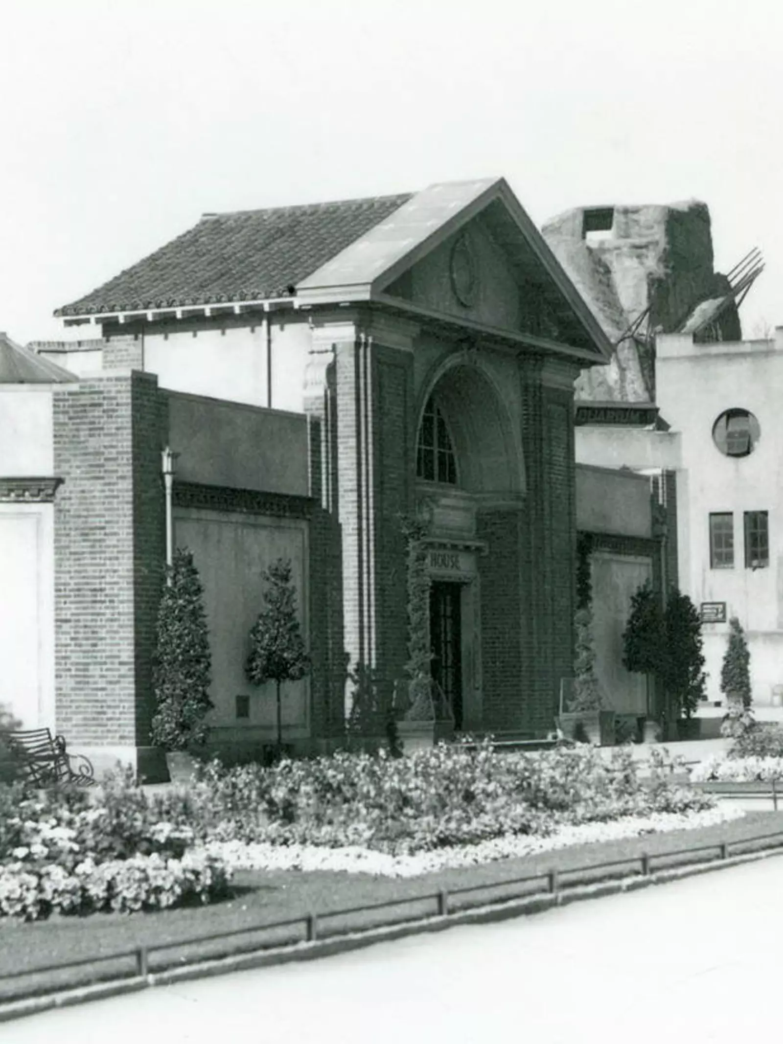 The Reptile House at London Zoo in 1928 with formal flower beds along the paths to the entrance. 