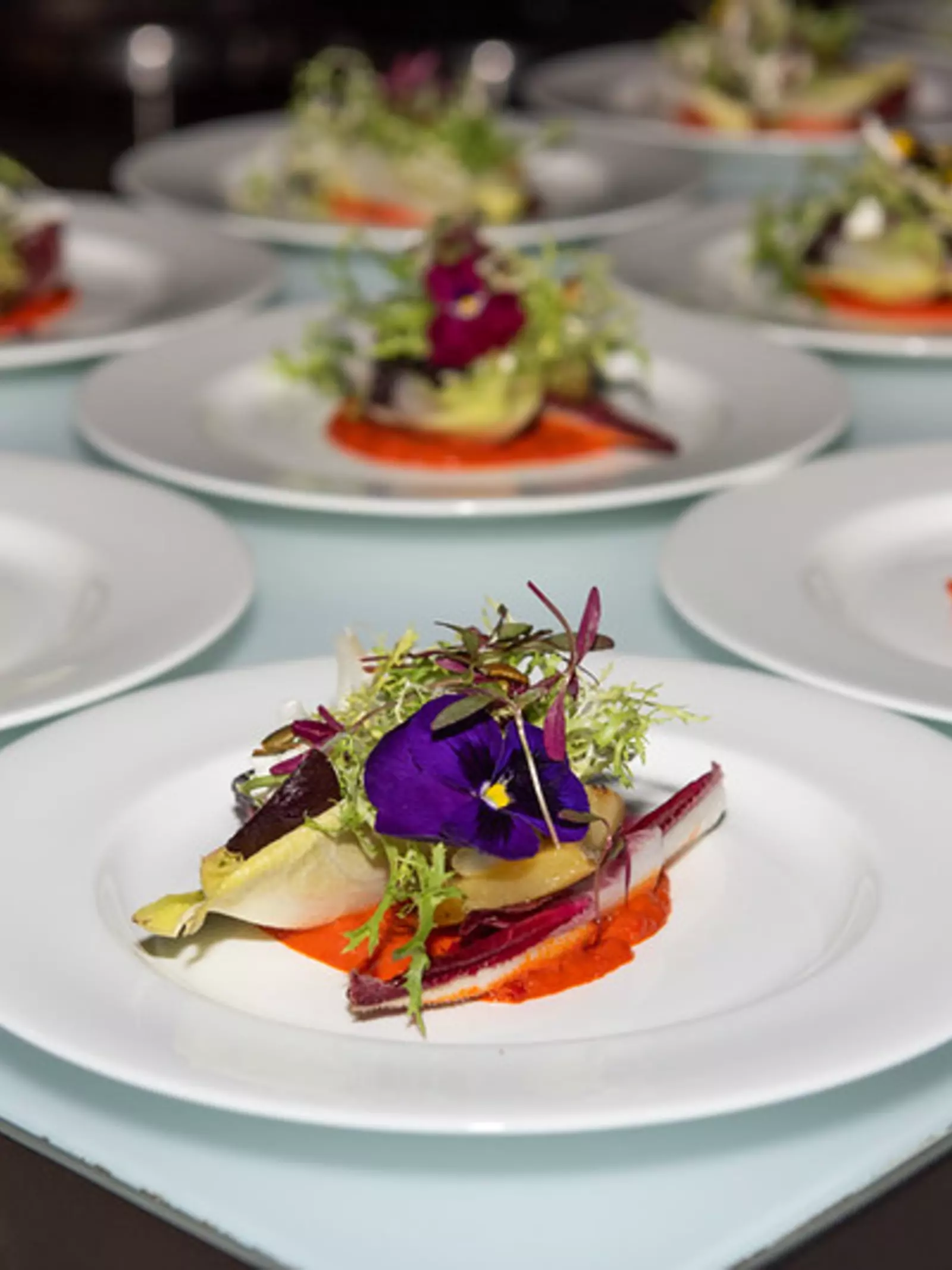Plates of food laid out on a table for an event 