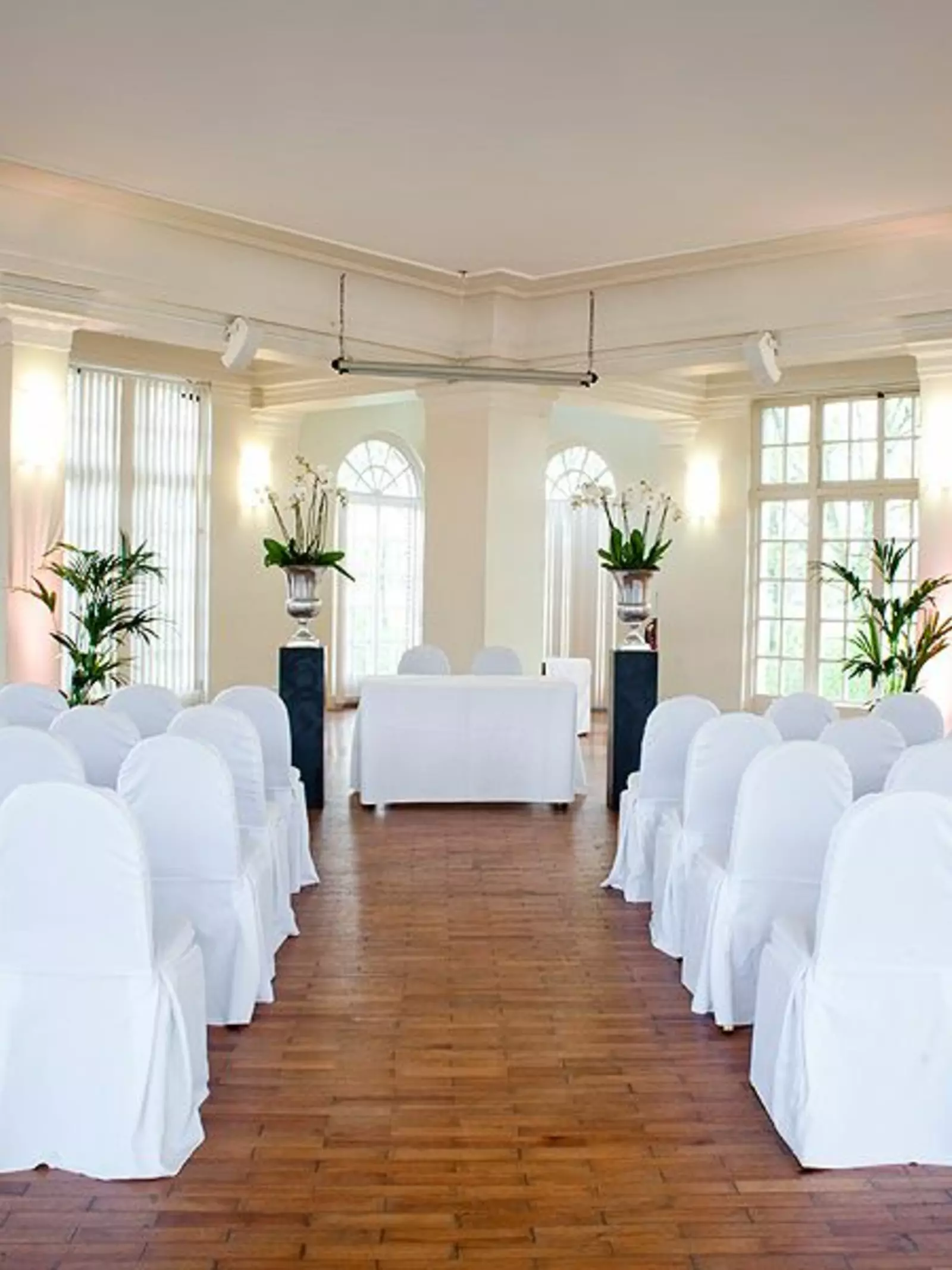 Mappin Pavilion set up for wedding ceremony with white chairs facing a table with two chairs side by side