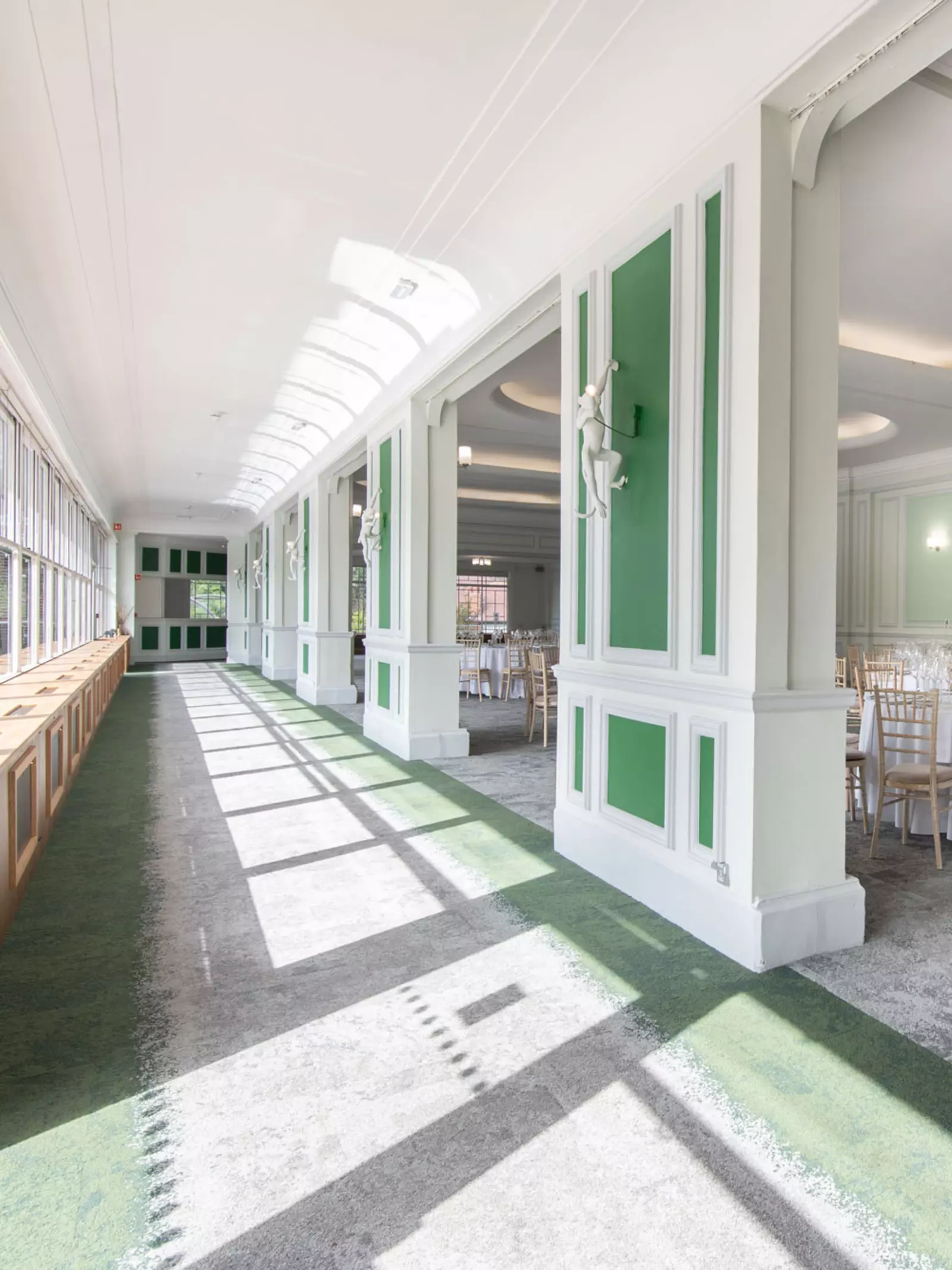 Prince Albert Suite interior, a long hall alongside tables and chairs 