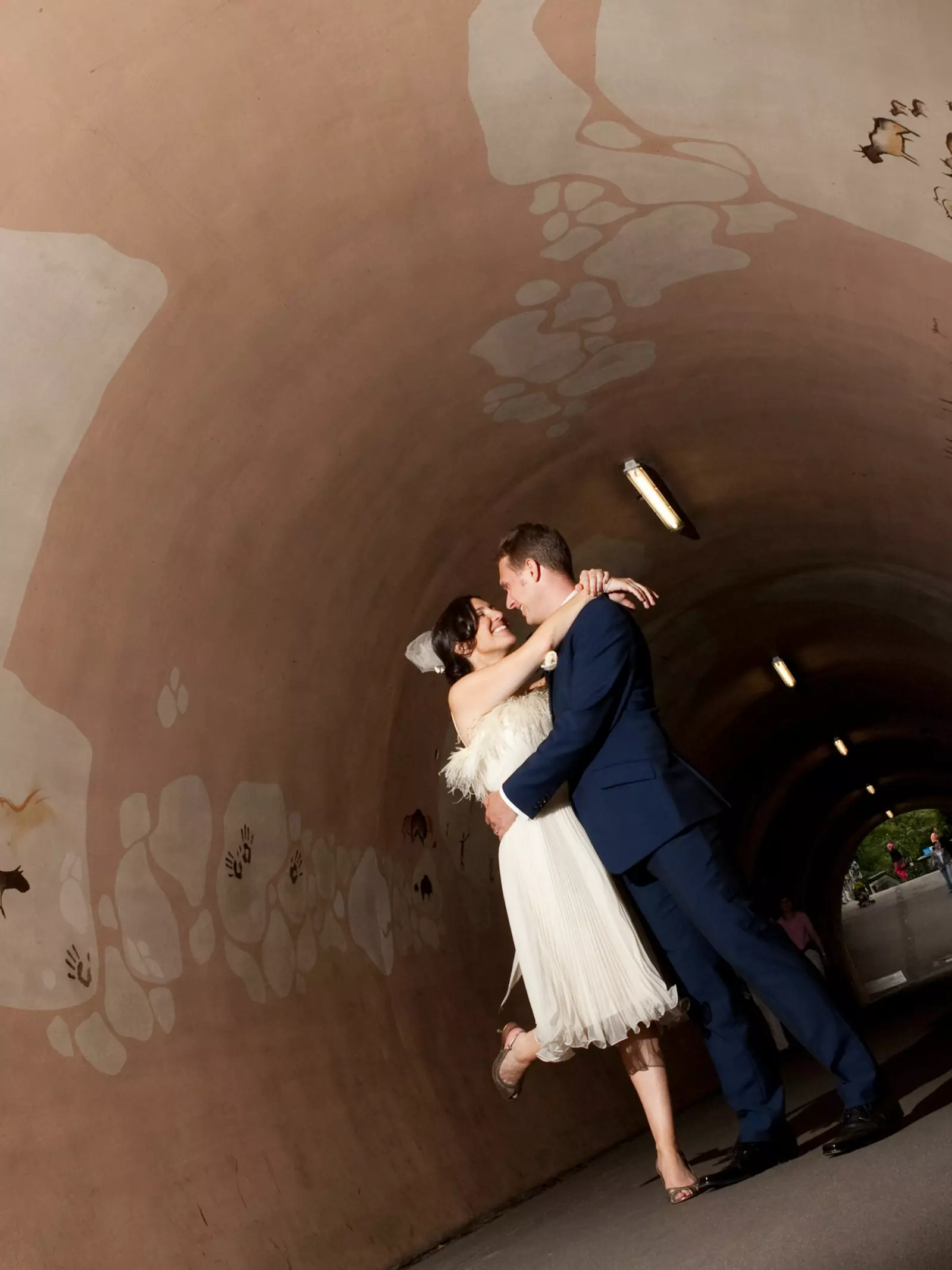 Wedding couple kissing in a tunnel at London Zoo