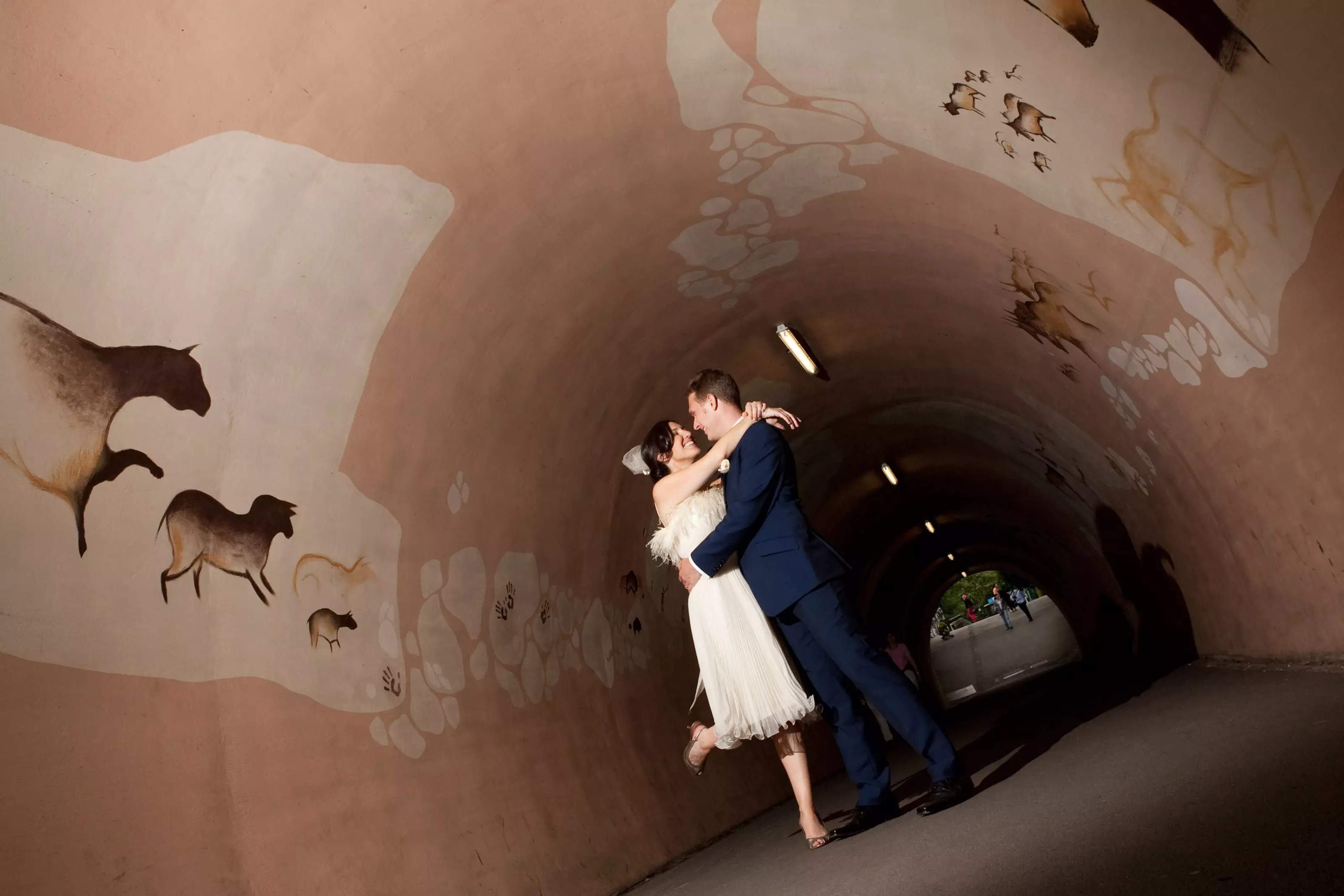 Wedding couple kissing in a tunnel at London Zoo