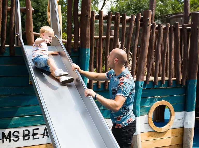 A father with his son on the slide in Animal Adventure at London Zoo