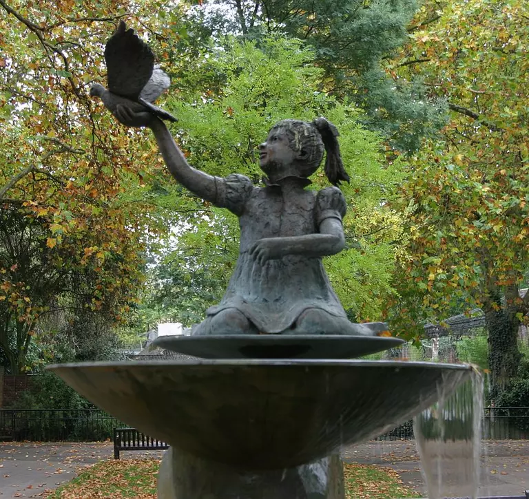 Statue fountain of child releasing a dove, Ambika Paul Fountain at London Zoo 