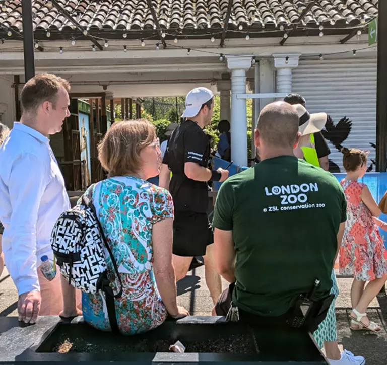 people looking at banksy mural